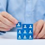 Human resources, social networking, assessment center concept, personal audit or CRM concept - recruiter complete team by one person. Employees are represented by blue glass cubes with icons.